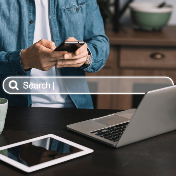 photo of a person holding a smartphone while working on a laptop and a tablet doing marketing, it may seem easy for an expert marketer, that is why they offer marketing made simple package