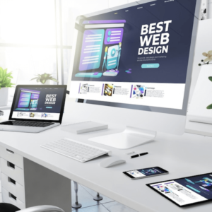 photo of a desk set up with a computer, laptop, tablet, and smartphone which is what a web designer uses in the website development package that they offer